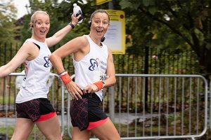 To women running in Meadow House vests