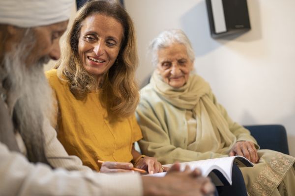 Two women and a man talking