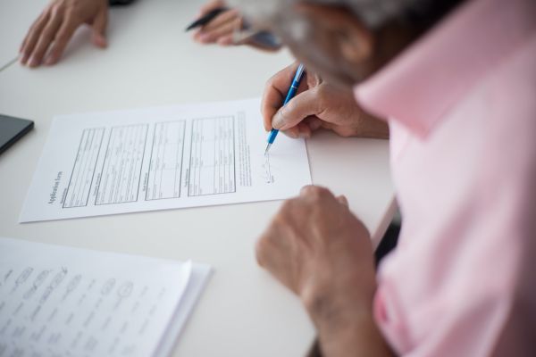 Woman signing a form