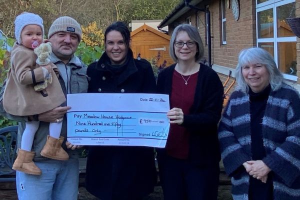 People holding a big cheque.