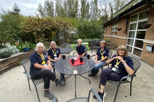Gardening volunteers sitting in the garden.
