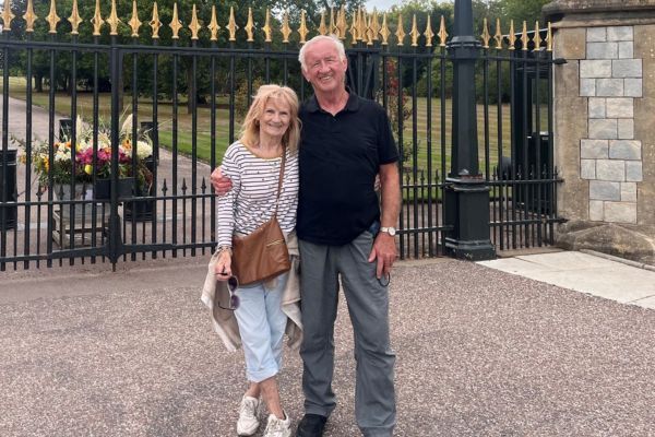 Michael and Marion standing in front of black railings.